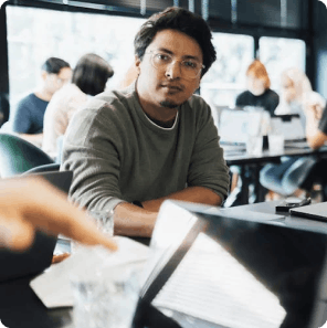 Professional working on laptop in office meeting